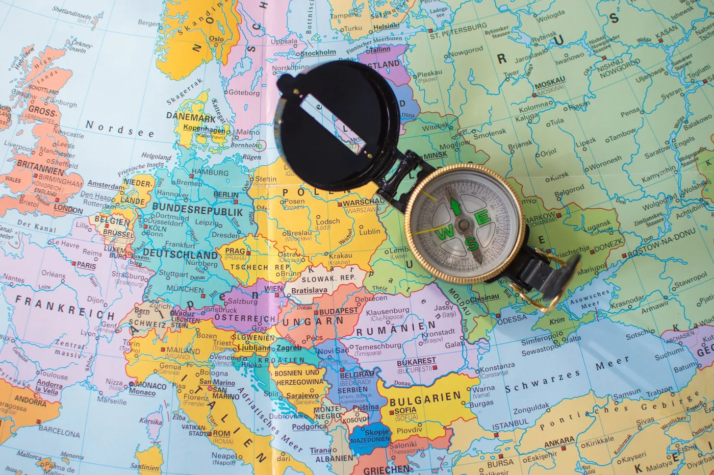 Compass lying on a map of Europe