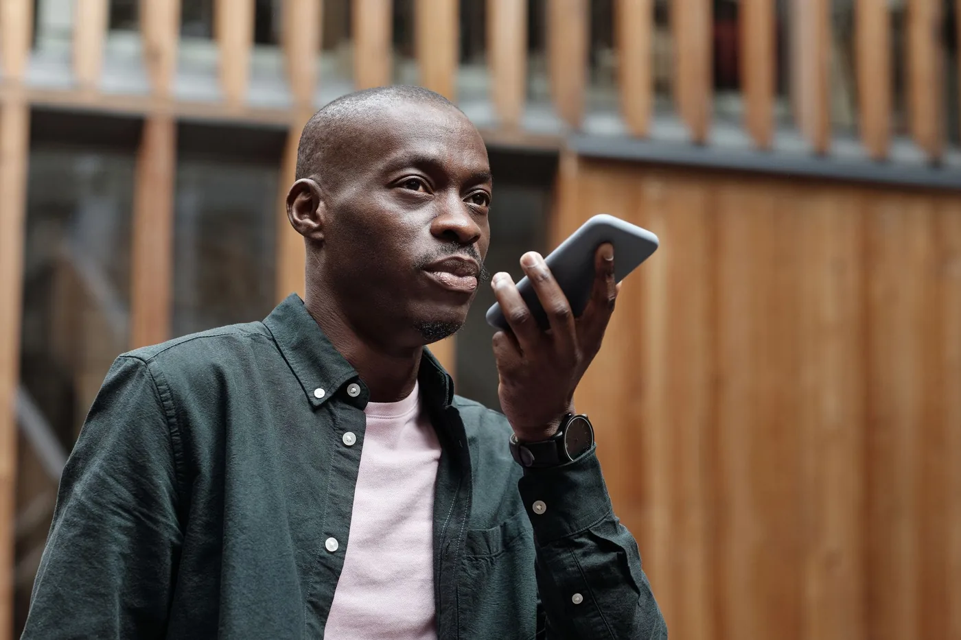 Man recording a voice message on his smartphone