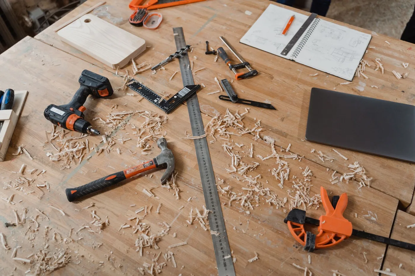 Carpentry workbench with tools, a steel ruler and wood shavings
